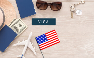 Flag of United States with passport and toy airplane on wooden background. Flight travel concept