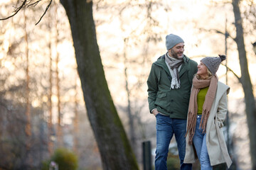 Romantic couple enjoying a walk in the park holding hands