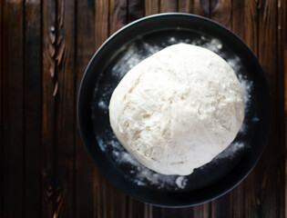 Process of raising the dough in a special basket. Dough made from natural sourdough. Wheat dough. Fermentation. Top view.	