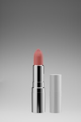 3D rendering scene of luxury silver packaging lipstick with pink tone isolated on gray background. Beauty makeup products realistic vector mockup