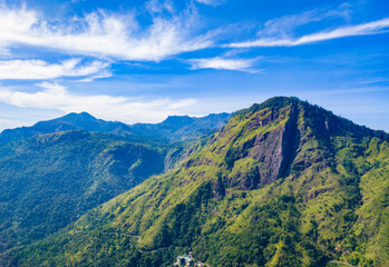 Beautiful mountain tropical landscape with green hills and blue sky. Photography for tourism background, design and advertising.