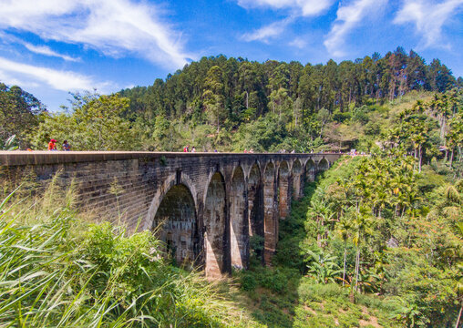 An old colonial nine-arch bridge in the jungles of Sri Lanka. Photography for tourism background, design and advertising.m