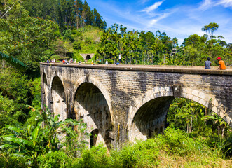 An old colonial nine-arch bridge in the jungles of Sri Lanka. Photography for tourism background,...