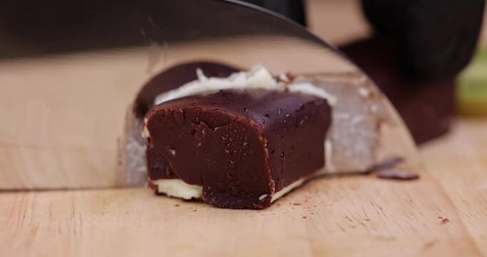 cut sweet green cottage cheese with kiwi flavor in chocolate glaze, delicious dessert cottage cheese in chocolate