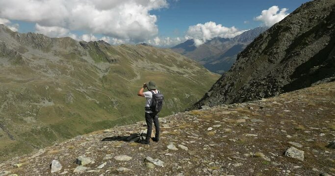 Hiker watching around the beauty of the Swiss mountains