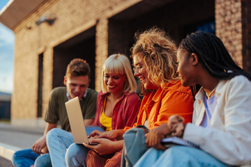 University students use laptop outside.