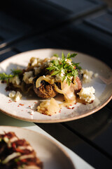 Delicious baked potatoes in a uniform with onions and lard