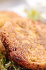 Macro photo of fried grated potatoes served with mushroom sauce and sour cream. Tasty Ukrainian dish