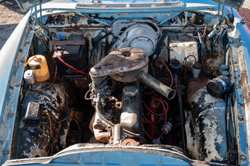 Detail of the engine of an old blue color, it is rusty