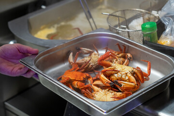 Several crabs cooked in a restaurant kitchen. Cooking and food concept.