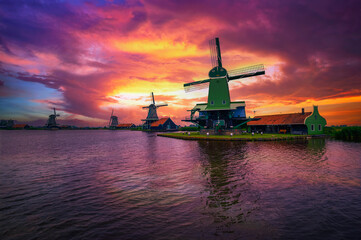 Dramatic sunset above farm houses and windmills of Zaanse Schans, Netherlands