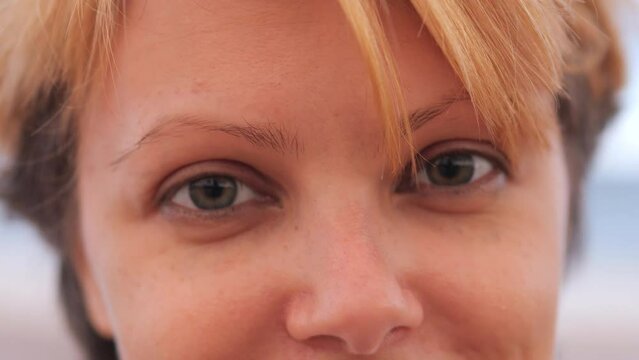 Beautiful young woman looking at camera. Close up.