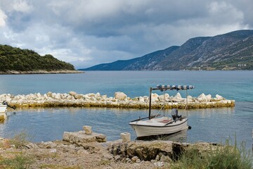 Fototapeta na wymiar A small old fishing boat moored to the harbor on the island of Korcula in Croatia.