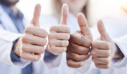 Hands, doctors and thumbs up together in closeup for motivation, agreement and team building in hospital. People, teamwork and hand gesture for diversity, support and trust for healthcare in clinic