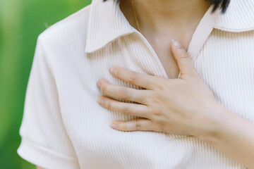 A woman has chest pain due to acute heart failure. Health care concept.