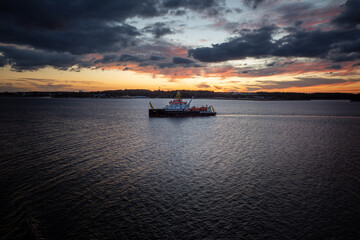 Naklejka na ściany i meble coasting vessel at sunset, baltic sea near klaipeda, lithuania