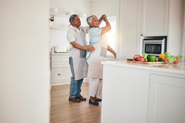 Happiness, cooking and senior couple dancing in the kitchen together feeling happy, excited and bonding in a home. Care, love and romantic old people or lovers dance enjoying retirement in a house