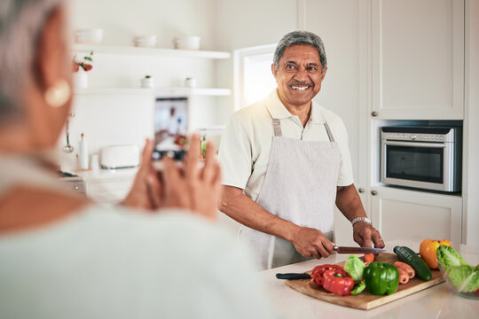 Kitchen cooking, senior couple and phone picture of old man, husband or nutritionist person with memory photo. Vegan, vegetables or people recording web video, smile or cutting lunch food ingredients
