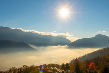 Mountain View over Trees and Lake Lugano with Cloudscape with Sunbeam on Clear Sky in Lugano,...