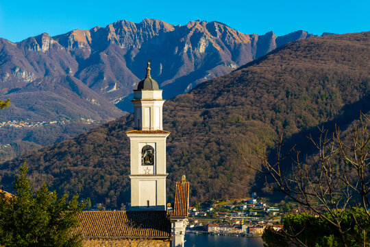 Church of Saints Fedele and Simone and Lake Lugano with Mountain in a Sunny Day in Vico Morcote, Ticino in Switzerland.
