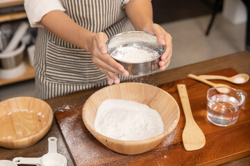 Woman Hand Sifting Bread Flour Before the Process of Kneading Dough
