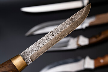 Damascus steel knives on a black background. Kitchen knives. background with japanese knife. A set...