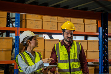 Warehouse worker checking goods and supplies on shelves with goods background in warehouse,Logistic and business export.