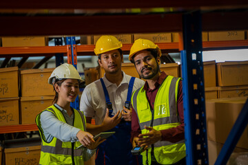 Warehouse employees uses digital tablet computer with Inventory checking software in the retail warehouse full of shelves with goods,Distribution Center.