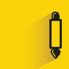 paint brush with shadow on yellow background