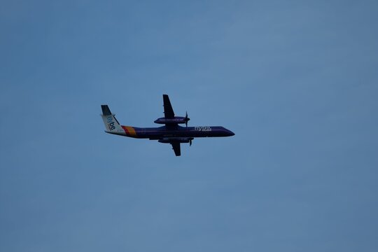 Beautiful shot of the Flybe airplane in flight in the blue sky