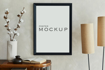 Minimalist composition of home interior with black mock up poster frame, lamp, vase with dried flowers, book and personal accessories. Home decor. Template.