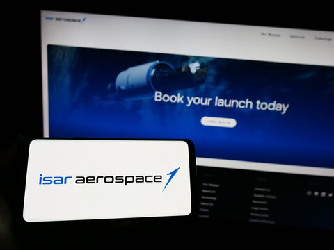 Stuttgart, Germany - 04-02-2023: Person holding smartphone with logo of company Isar Aerospace Technologies GmbH on screen in front of website. Focus on phone display.
