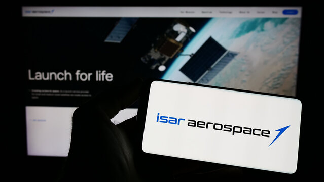 Stuttgart, Germany - 04-02-2023: Person holding mobile phone with logo of company Isar Aerospace Technologies GmbH on screen in front of business web page. Focus on phone display.
