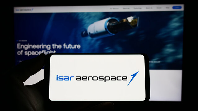 Stuttgart, Germany - 04-02-2023: Person holding cellphone with logo of company Isar Aerospace Technologies GmbH on screen in front of business webpage. Focus on phone display.