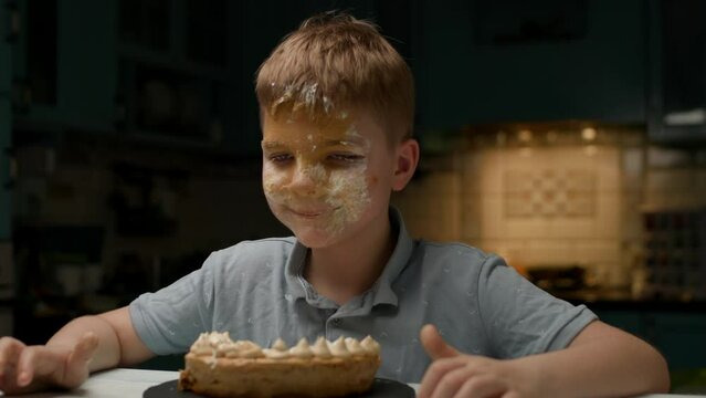 Kid After Face Cake Smash. Happy birthday boy eating sweets. Child with dirty face.