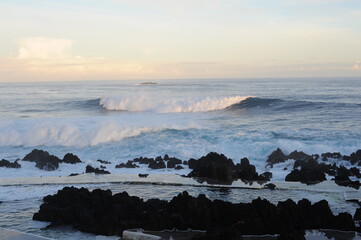 Waves breaking and crushing on the rocks on the Atlantic Ocean on coastline and seashore of Madeira...