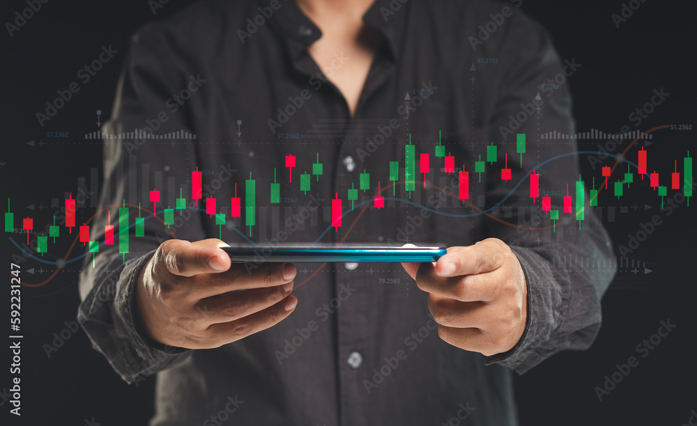 Poster businessman or trader looking at a stock graph on a virtual screen with a mobile phone