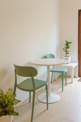 White wooden table and green chairs , Minimal furniture in dining room modern interior.