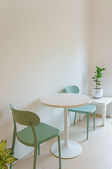White wooden table and green chairs , Minimal furniture in dining room modern interior.