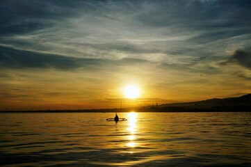 Fototapeta premium Beautiful view of sunrise over a sea with a cloudy sky
