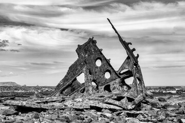 Grayscale shot of the historic SS Speke Shipwreck on a field