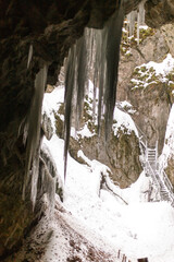 Fototapeta na wymiar from inside a cave with icicles and snow