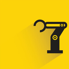 industrial robotic arm with shadow on yellow background