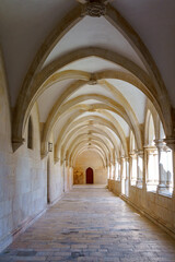 Fototapeta na wymiar monestary corridors with arches and paved walkways
