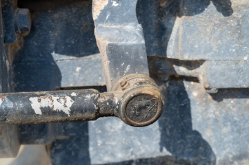 Detail of old tractor and clutch mechanism on side of engine with grease zerk