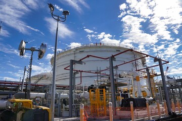 Industrial plant under a cloudy blue sky