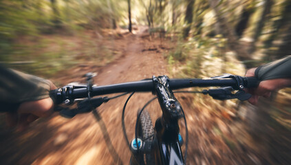 Fototapeta na wymiar POV, mountain bike and person cycling in forest, park and path for adventure, speed and motion blur. Closeup perspective of bicycle handle, athlete and outdoor action in nature, off road and sports