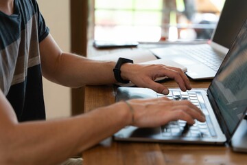 Person sitting at a laptop and typing something