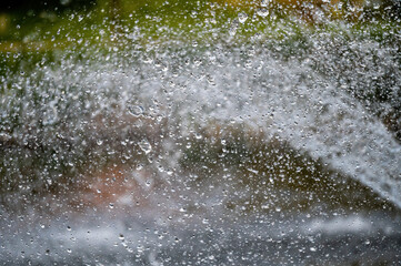 water splash with small drops in fountain, abstract natural background, selective focus
