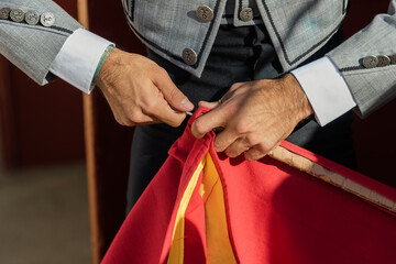 Crop matador preparing sword for bullfight